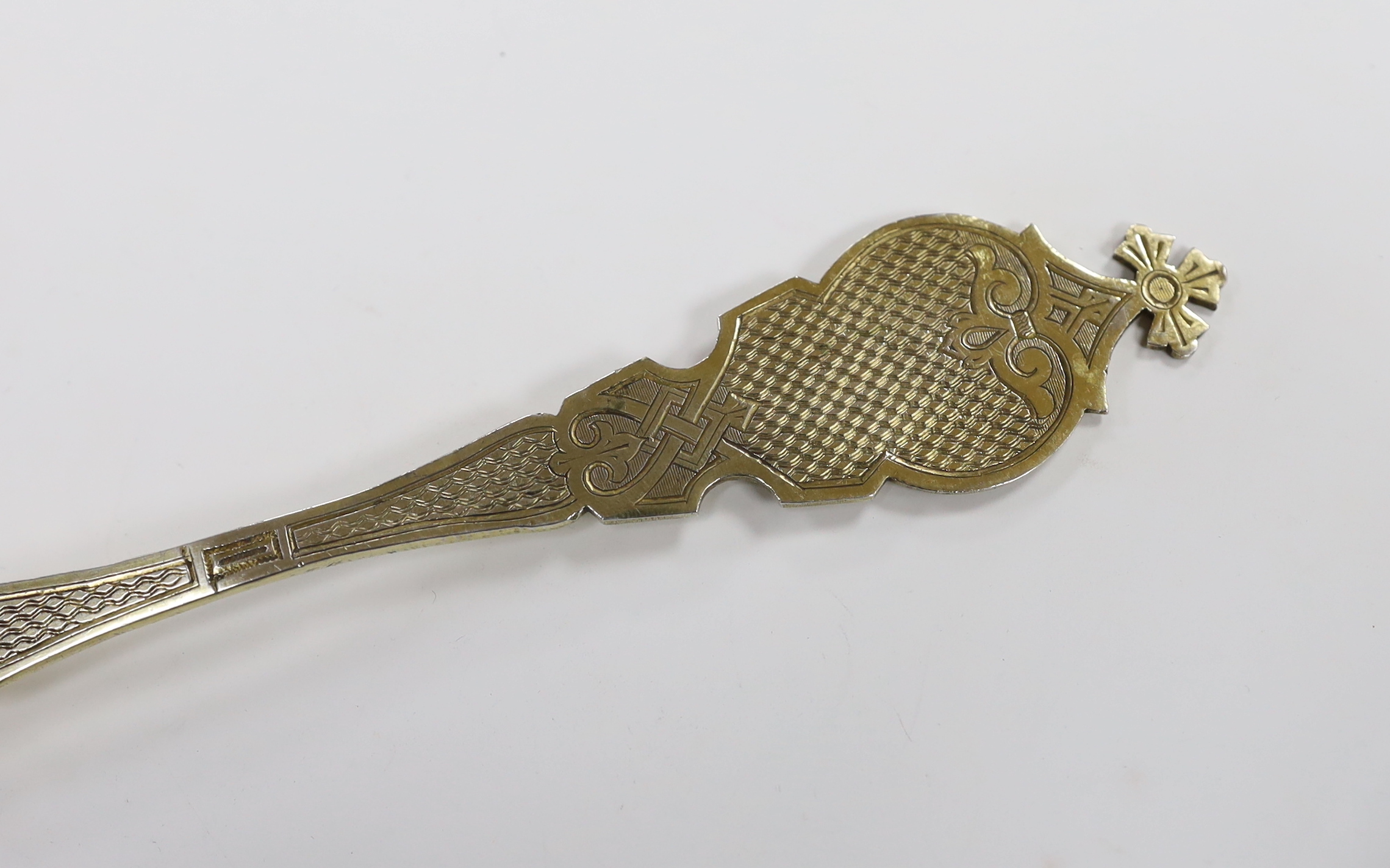 A late 19th/early 20th century Russian 84 zolotnik gilt anointing spoon, with engraved decoration, 22.9cm, 75 grams.